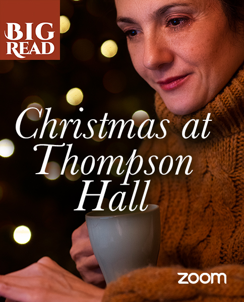 a woman wearing a jumper holding a hot drink