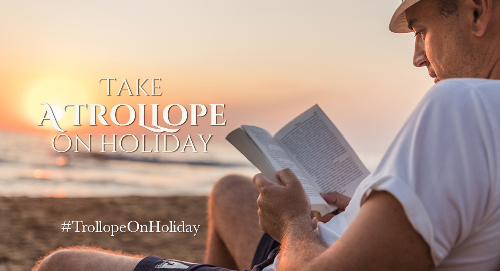 man reading a book on a beach